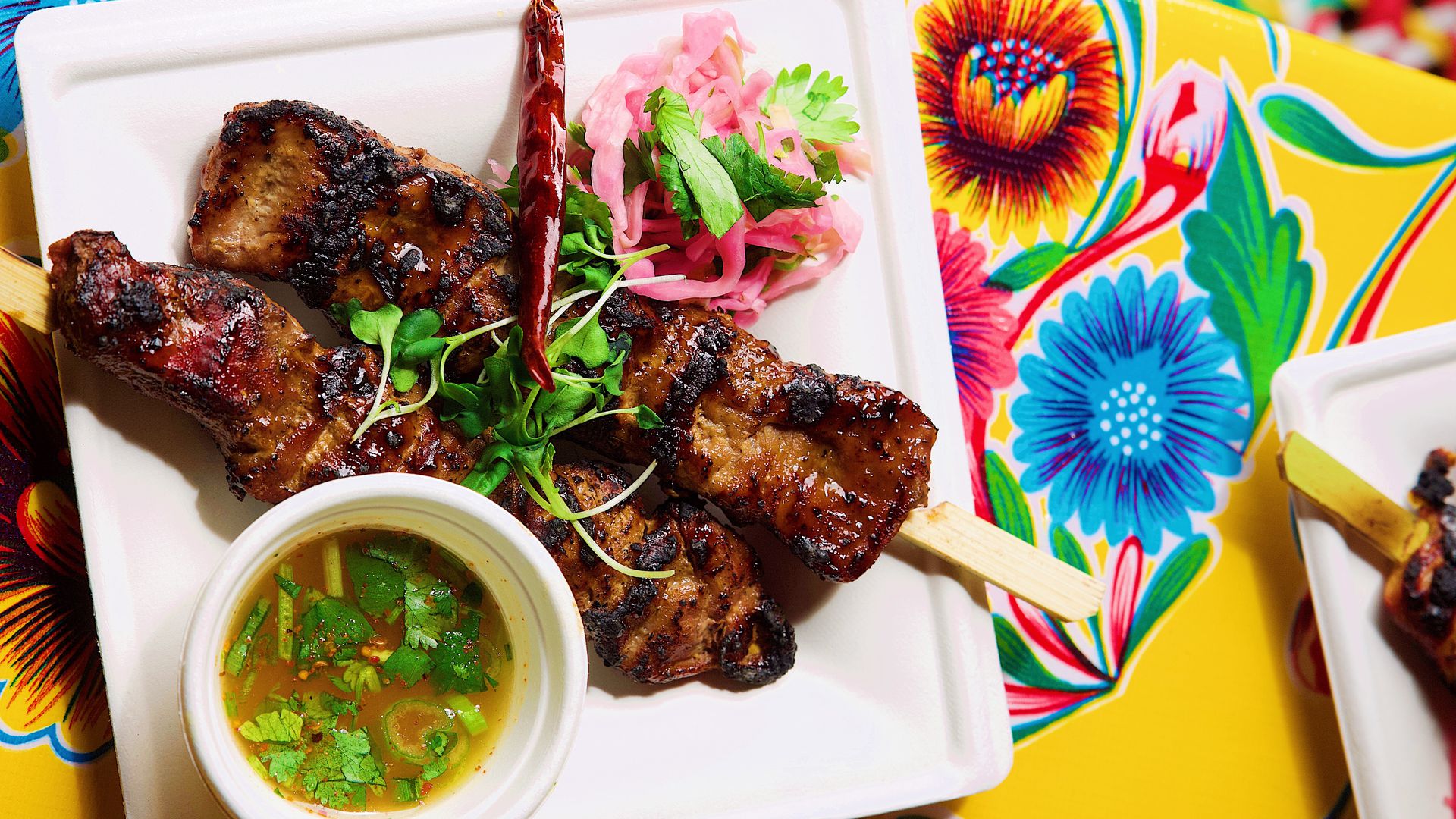 exciting laotian american restaurant opens with southeast asian burgers and skewers in austin