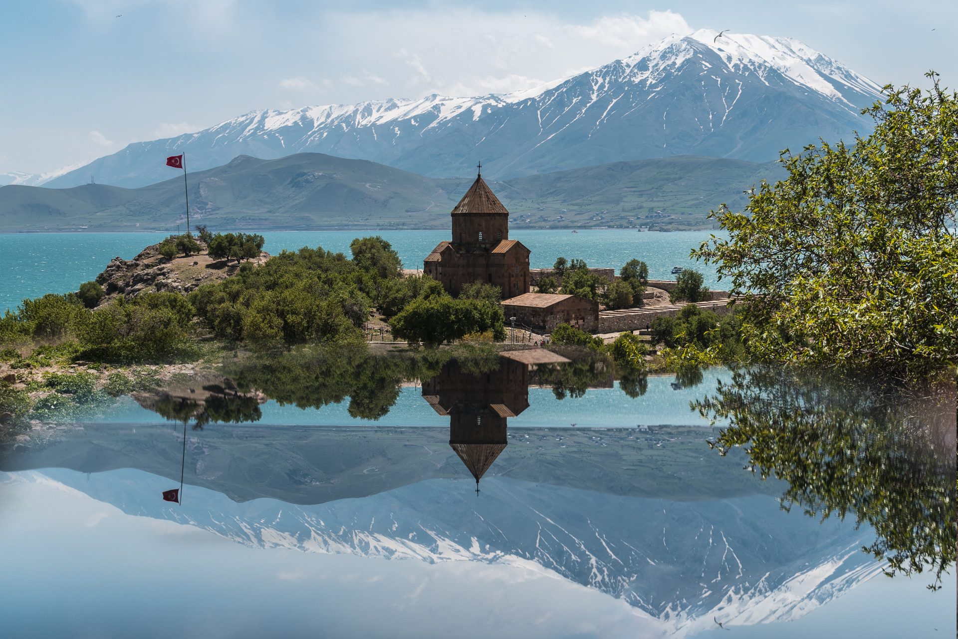 <p>This island in eastern Turkey is a historical and culturally rich place for its natural beauty and its Armenian Cathedral. Surp Khach (the Cathedral of the Holy Cross) was built in the 10th century by Armenian King Gagik I. You can see intricate stone carvings there, especially in its exterior reliefs with biblical scenes, animals, and geometric motifs. The cathedral is one of the finest examples of Armenian medieval architecture and a masterpiece of medieval art.</p>