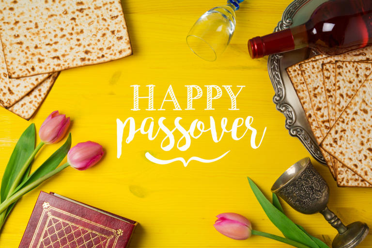 jewish-holiday-passover-pesah-celebration-with-matzoh-tulip-flowers-and-wine-bottle-on-yellow-wooden-background-view-from-above
