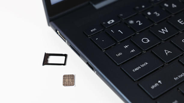 HP Elite Dragonfly G3 and a Nano-SIM card ready to be installed. (Image credit: Daniel Rubino)