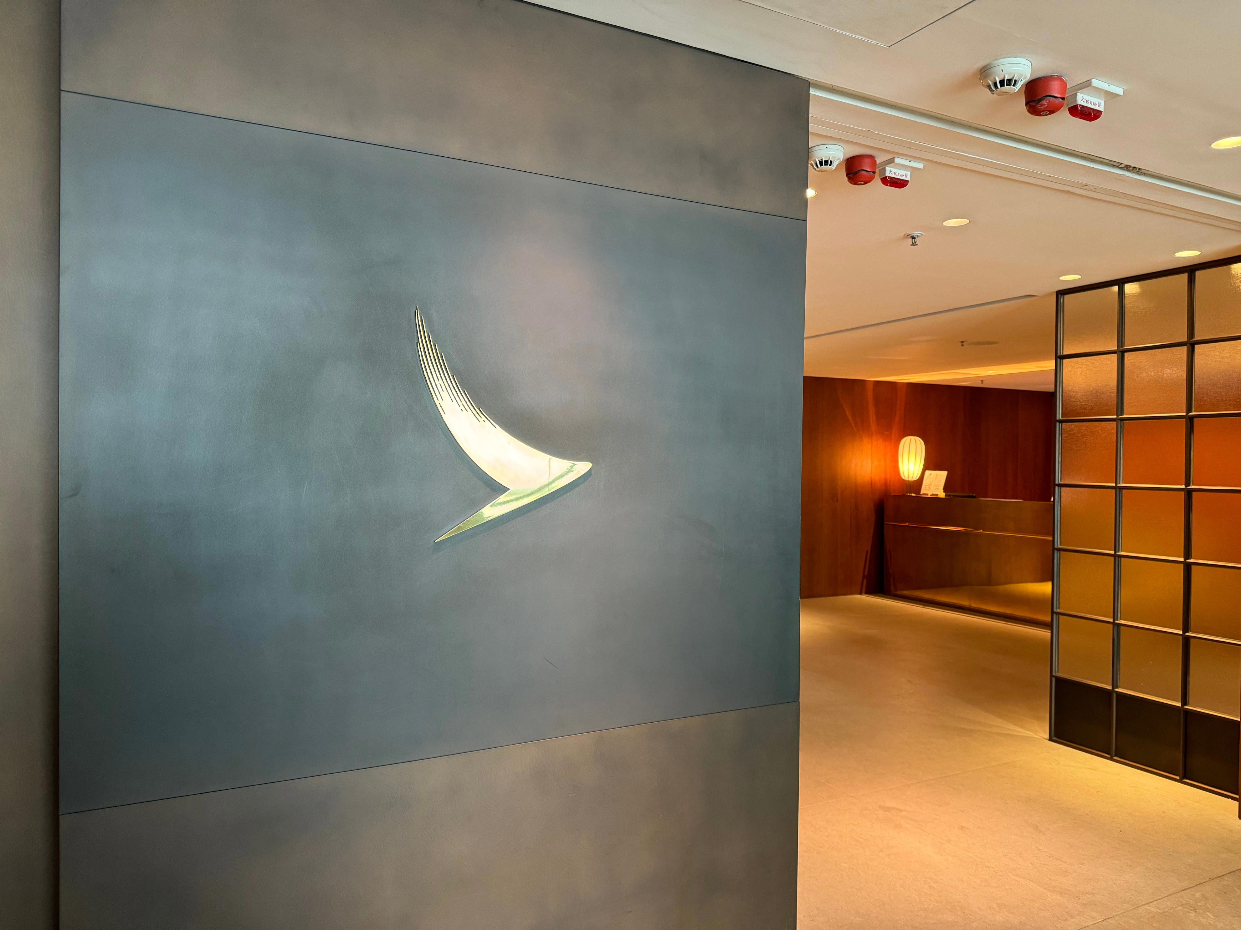 <p>Cathay Pacific has two lounges for first-class fliers in this airport — The Wing and The Pier — but the latter was closest to me, so I chose to visit it during my travels. </p><p>According to Cathay Pacific's website, the lounge is available from 5:30 a.m. to 12:30 a.m. daily. It's located in terminal one, near gate 63.</p><p>To enter the lounge, I scanned my boarding pass at the check-in station. Unlike other lounges that I've been to, there was no line or overcrowding. I was able to walk right in. </p><p>From the moment I entered, it felt like a <a href="https://www.businessinsider.com/british-airways-first-class-suite-review-photos-2023-7">premium airport lounge experience</a>.</p>