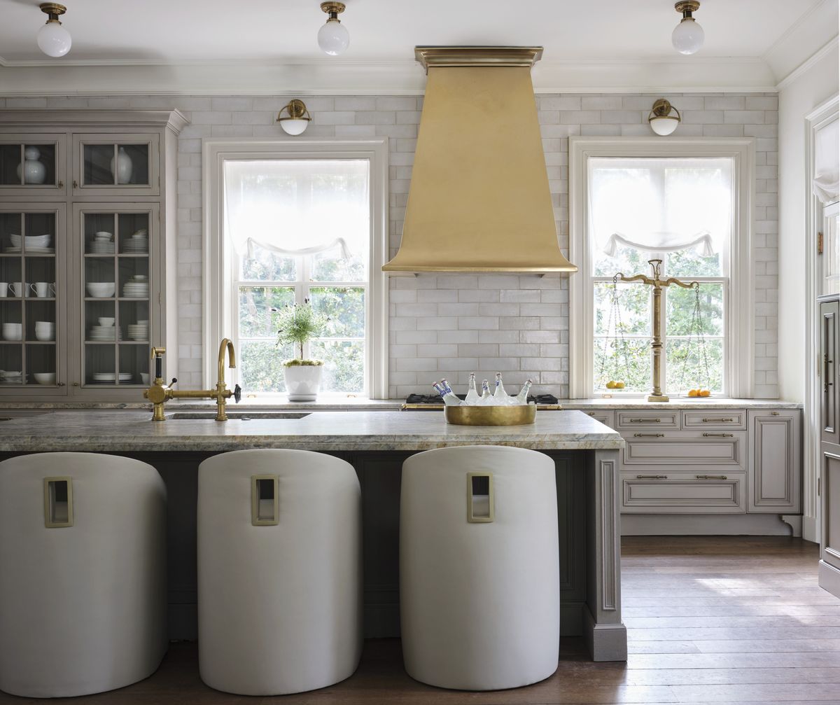 <p>In the kitchen of <a href="https://www.veranda.com/decorating-ideas/house-tours/a43474742/pink-palace-atlanta-house-tour/">this 1926 Buckhead residence</a>, a French bistro-inspired brass hood from <a href="https://francoisandco.com/">François & Co.’s</a> new line shines against existing gray tilework and cabinets in a similar hue. A mix of drawers in various sizes make up lower cabinets, while glass-front doors above show off pretty tableware. Lighting, <a href="https://go.redirectingat.com?id=74968X1553576&url=https%3A%2F%2Fwww.visualcomfort.com%2F&sref=https%3A%2F%2Fwww.veranda.com%2Fdecorating-ideas%2Fg35091957%2Fkitchen-cabinet-ideas%2F">Visual Comfort & Co.</a>. Stools, <a href="https://bradleyusa.com/">Bradley</a></p>