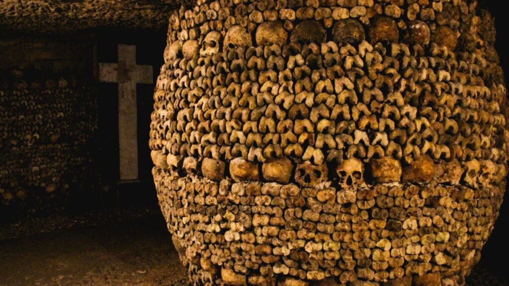 <p>A lack of grave space in the 18th century led Paris city officials to transfer remains to an underground site of tunnels below Paris streets. One visitor recalls, “So many skulls stacked in mounds staring at you. Thousands of them. They were all people once. It was creepy.”</p>