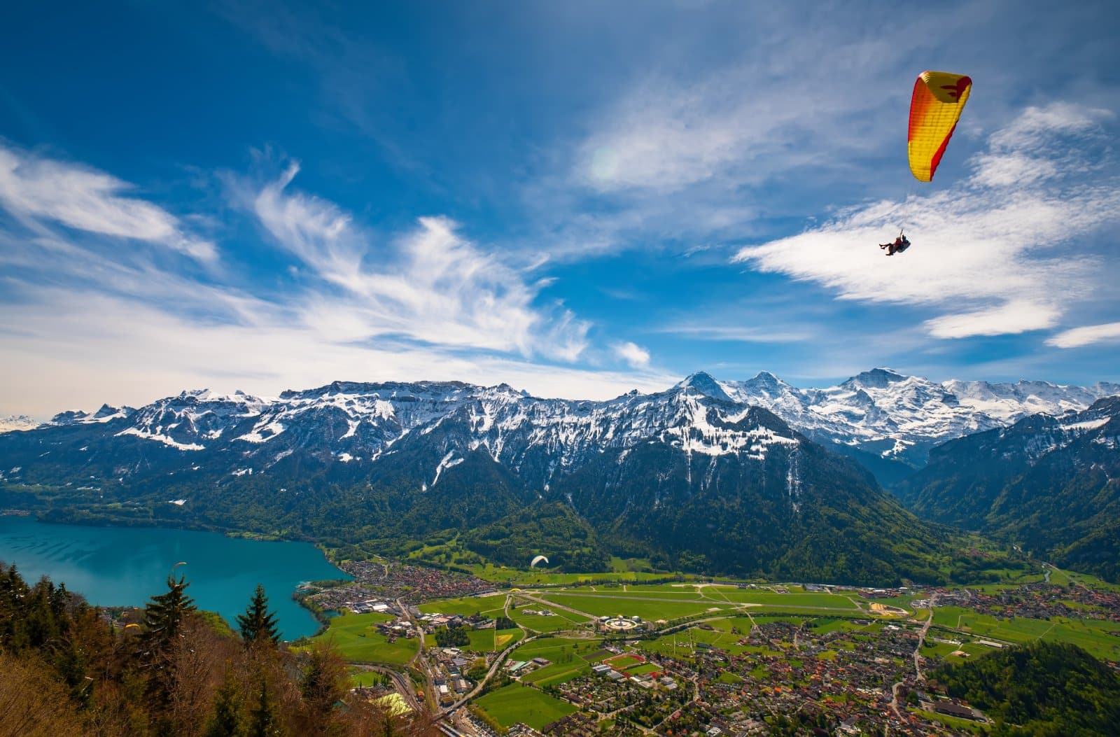 <p class="wp-caption-text">Image Credit: Shutterstock / Haidamac</p>  <p><span>The thrill of paragliding in Interlaken offers more than just an adrenaline rush; it presents a bird’s-eye view of Switzerland’s breathtaking landscapes. Floating above the emerald lakes of Thun and Brienz and gazing at the majestic peaks of the Eiger, Mönch, and Jungfrau, you’ll experience a sense of freedom and awe that’s hard to find elsewhere. Interlaken is renowned for its welcoming attitude towards LGBTQ+ adventurers, ensuring that a sense of belonging and acceptance matches the exhilaration of flight. The town itself, nestled between lakes and mountains, is a hub of outdoor activity, where the air is filled with the spirit of adventure. Paragliding here is accessible to all, with tandem flights guided by experienced pilots who prioritize safety and inclusivity, making it an unforgettable way to witness the beauty of the Swiss Alps.</span></p>
