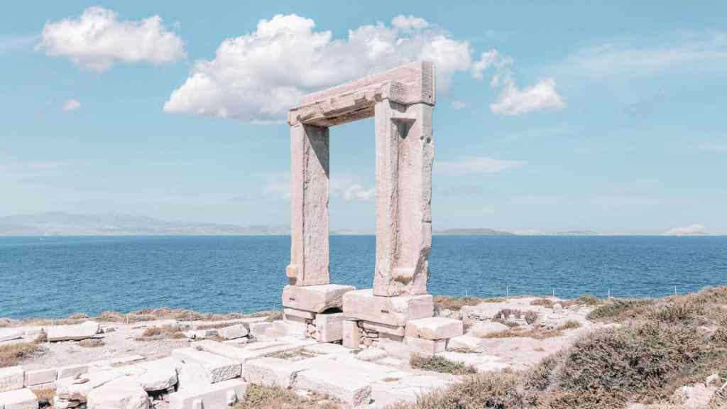 <p>If you arrive at Naxos Island on a ferry, the first thing your gaze will likely set upon is the Portara Gate, erect high on the islet of Palatia. This massive marble architectural masterpiece is what remains of the 6th-century BC temple of the Greek God Apollo. This historical site leaves you with a sense of tranquility, its colossal size in all its glory, and the magnificent view that will leave you breathless.</p><p class="has-text-align-center has-medium-font-size">Read also: <a href="https://worldwildschooling.com/the-temple-of-poseidon-at-cape-sounion-greece/">Cape Sounion, Greece Travel Guide</a></p>