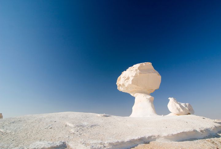 <p>Have you ever heard of the White Desert of Egypt? It is a surreal landscape of chalk rock formations shaped by wind and sand over millennia. The stark white rocks, contrasted against the deep blue sky, create an otherworldly atmosphere reminiscent of a lunar landscape. Camping under the stars in this ethereal desert is an unforgettable experience.</p>