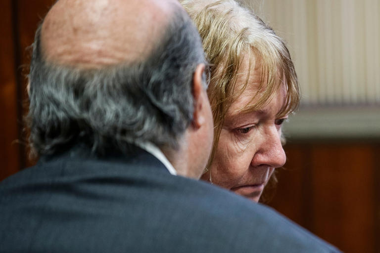 Marshella Chidester, 66, of Newport, talks to her attorney Bill Colovos during her arraignment at First District Court in Monroe on Tuesday, April 23, 2024.