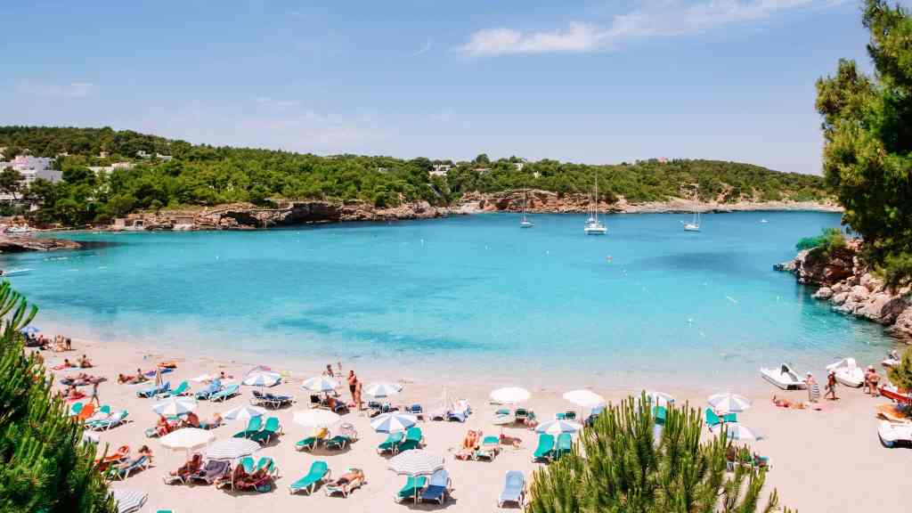<p>Another popular hot beach destination in Europe in May is Ibiza. Like Andalusia, this Balearic island is known for its tropical beaches. However, you may know Ibiza more as a party destination. When you’re not partying the night away on the Ibiza Strip, you’ll likely sunbathe on one of the many beaches.</p><p>The most popular beach in Ibiza is Playa d’en Bossa, the island’s longest 1.8-mile (3-kilometer) beach with crystal-clear turquoise waters, soft white sand, and lush pine trees. Meanwhile, San Vicente Ibiza and Playa Niu Blau are two relaxed beach areas that offer an escape from the hustle and bustle. In May, the average temperature in Ibiza is 71.6°F (22°C).</p><p class="has-text-align-center has-medium-font-size">Read also: <a href="https://worldwildschooling.com/natural-wonders-in-europe/">Breathtaking Natural Wonders</a></p>