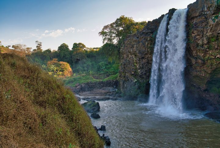 <p>Ethiopia’s Blue Nile Falls, known as “Tis Abay,” cascades over dramatic cliffs, creating a spectacular display of natural beauty. Where mist from the falls gives rise to rainbows, adding to the enchantment of this awe-inspiring sight. Visiting the Blue Nile Falls offers a refreshing escape into the heart of Ethiopia’s rich terrain.</p>