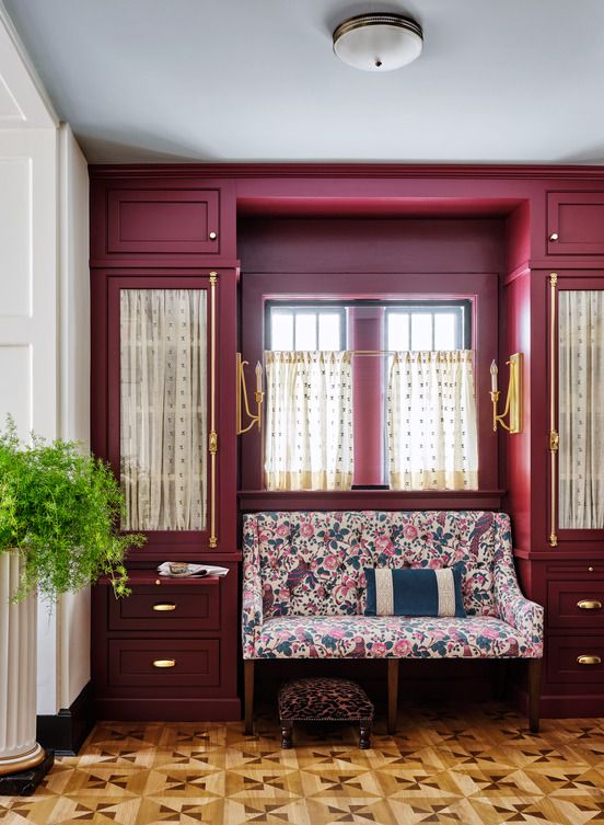 <p>The deep burgundy in this butler's pantry by interior <a href="https://www.mccoryinteriors.com/">designer Kristen McCory</a> was inspired by a <a href="https://www.frenchranges.com/">Lacanche</a> range and hood in the adjacent kitchen. The floral settee print takes a queue from the rich floor-to-ceiling cabinetry that's lined with pleated white fabric to conceal less attractive items stored behind.</p>