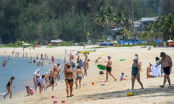 Tourists at a beach in Phuket, Thailand, on March 20, 2020. Photo by AFP
