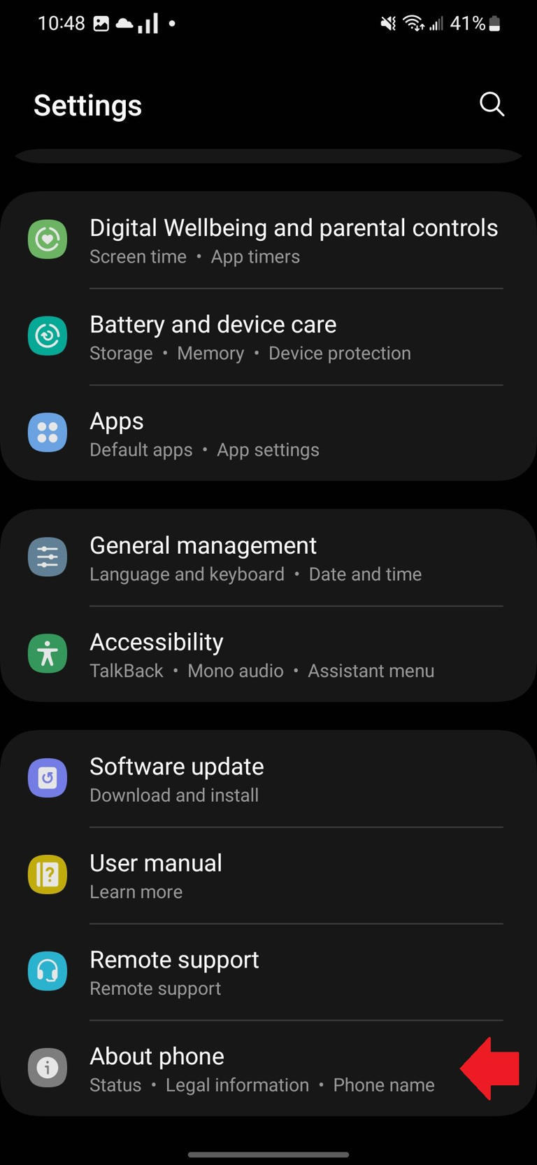 The Samsung Settings app with a red arrow pointing to the About phone section