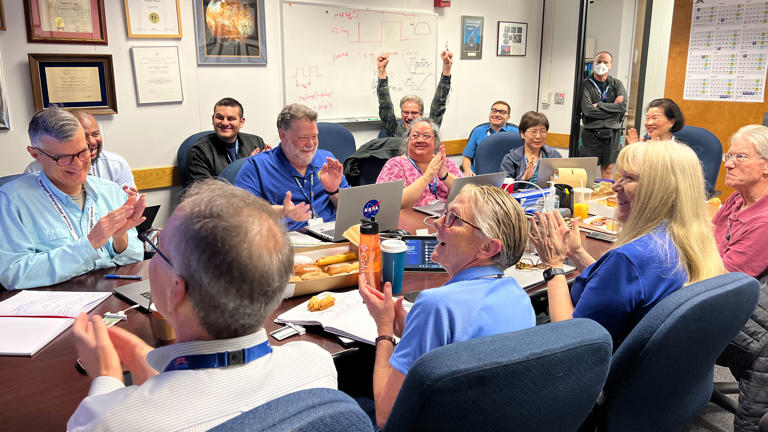 Members of the Voyager 1 flight team celebrate after receiving health and status data from the spacecraft. Next, engineers need to enable the probe to start sending science data again.