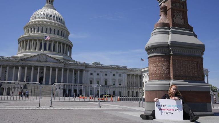 Jennifer Gay, a TikTok content creator, sits outside the U.S. Capitol, Tuesday, April 23, 2024, in Washington as Senators prepare to consider legislation that would force TikTok's China-based parent company to sell the social media platform under the threat of a ban, a contentious move by U.S. lawmakers. - Mariam Zuhaib/AP