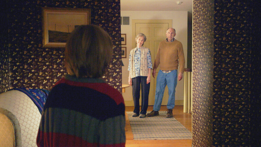 <p>Set in rural Pennsylvania, The Visit centers primarily on Becca (Olivia DeJonge) and Tyler (Ed Oxenbould), who are meeting their estranged grandparents for the first time. Their mother, Loretta (Kathryn Hahn), ran away from home when she was a teenager and hasn’t spoken with Nana (Deanna Dunagan) or Pop Pop (Peter McRobbie) for 15 years. Wanting to learn more about their mother’s upbringing, Becca and Tyler convince Loretta to let them stay with Nana and Pop Pop for five days while she goes on a cruise vacation with her boyfriend.</p><p>Becca brings her video cameras with her to document the entire experience, and The Visit starts out with a wholesome vibe. Nana and Pop Pop seem like genuinely nice people, but they establish two very suspicious ground rules: don’t go in the basement, and don’t leave the bedroom after 9:30 p.m. On the first night, Becca sneaks out of the bedroom she’s sharing with Tyler to grab a cookie from the kitchen, and is disturbed by Nana’s behavior.</p>