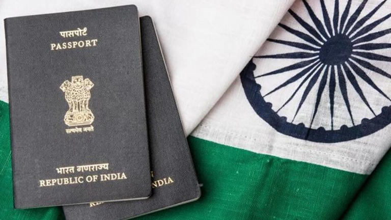 Indian passport and authentic indian tricolour flag made up of khadi or pure cotton material - Stock image (Getty Images/iStockphoto)