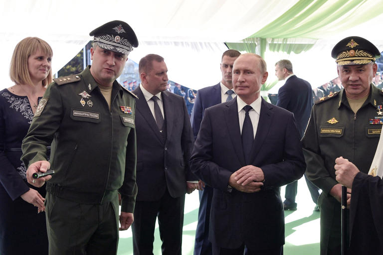 Russia's President Vladimir Putin (C), Russian Defense Minister Sergei Shoigu (R) and Deputy Minister of Defense of the Russian Federation Timur Ivanov (L) visit the military Patriot Park in Kubinka, outside Moscow, on September 19, 2018. Ivanov was arrested on suspicion of taking bribes on Tuesday, marking a rare arrest of a member of the Kremlin’s elite.