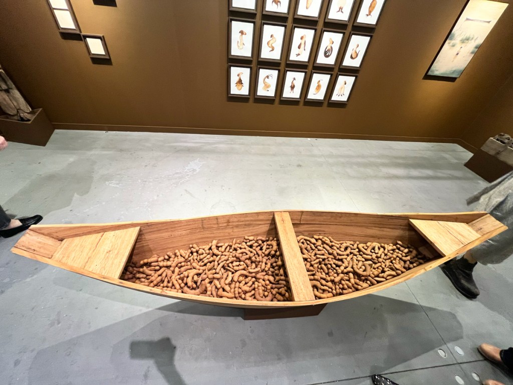 <p>Collaboration guides through the work of Davi de Jesus do Nascimento, who comes from a family of carpenters from the São Francisco River Basin in Brazil’s Minas Gerais state. At the center of the booth is a large boat built by the artist’s father and filled with dozens of pieces of raw tamarind. On an exterior wall is a photo of the artist wrapped in a fisherman’s net; above him stands his father, who has fished the artist out of the river. The image was taken by do Nascimento’s brother. On one wall are beguiling brown drawings of imagined creatures from the depths of the São Francisco River, while another wall includes several Polaroids of the artist, onto which he has affixed insect appendages.</p> <p><a href="https://www.artnews.com/list/art-news/market/frieze-new-york-2024-best-booths-1234705628/">View the full Article</a></p>