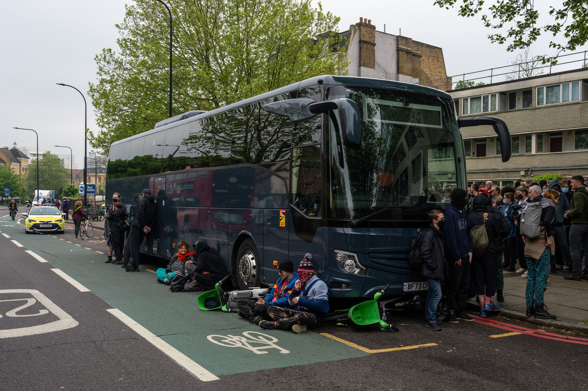 'refugees are welcome here!': protesters in peckham block coach from taking asylum seekers to bibby stockholm barge