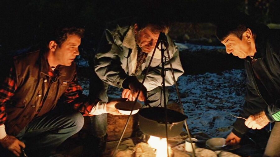<p>Honestly, the entire camping scene in Star Trek V perfectly distills the spirit of The Original Series, and our trio of core characters–Kirk, Spock, and McCoy–are all in rare form. It’s hard not to grin as the two humans try to teach the incredulous Vulcan to sing “Row, Row, Row Your Boat,” and that grin only gets bigger as you hear Spock call the favorite human campfire snack a “marshmelon.” Again, though, things veer toward the morbidly profound when Kirk speculates that the trio spend their shore leaves together because they don’t have families like others do (sadly oblivious to the fact that his found family is right in front of him).</p>
