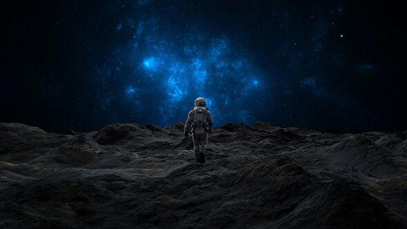 Astronaut ascends a lunar hill against a backdrop of brilliant cosmic clouds and starry sky. 3d render