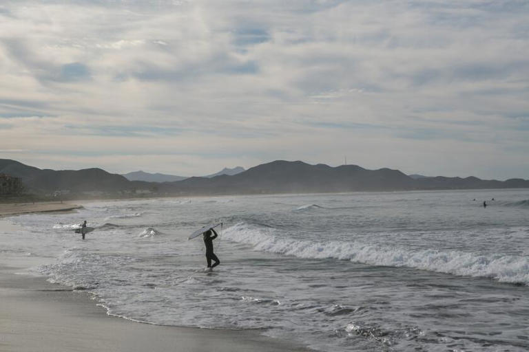 Surfers enter the water in Baja California, Mexico. ((Meghan Dhaliwal / For The Times))