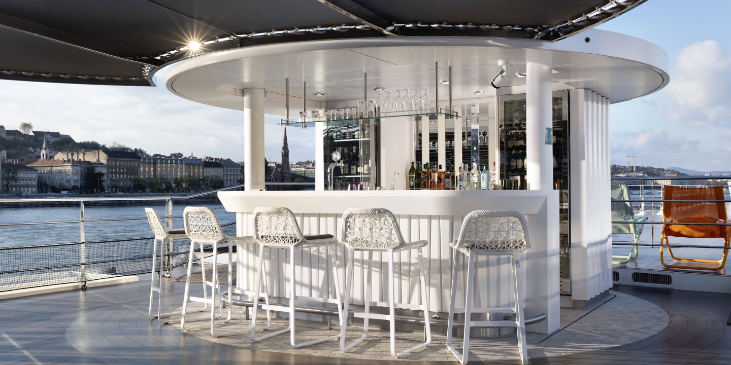 <p>The <i>S.S. Victoria</i>‘s upper-deck Vista lounge and bar can conveniently collapse to clear low bridges.</p><p>Ian Schemper/Uniworld Boutique River Cruises</p><p>On Day Two of our European river cruise with <a class="Link" href="https://fave.co/3QwYipX" rel="noopener nofollow sponsored">Uniworld Boutique River Cruises</a> in late March, my brother and I returned from dinner one night to a stateroom transformed by turndown magic. The lights were dimmed, curtains drawn, and duvets pulled back enticingly, chocolates nearby.</p><p>But the excitement over sailing on my first-ever <a class="Link" href="https://www.afar.com/travel-inspiration/cruise/river-cruise" rel="noopener">river cruise</a>—a week along the waterways of Belgium and the Netherlands—with Jason, also a rookie, still hadn’t faded, and I wasn’t the least bit sleepy. Instead of crawling into bed, I opened the curtains to see what was happening out on the water.</p><p>Turns out, not much—because the 110-passenger <a class="Link" href="https://fave.co/3UKaara" rel="noopener nofollow sponsored"><i>S.S. Victoria</i></a> was deep inside a lock on the Scheldt River somewhere between Brussels and Antwerp. Inches beyond our floor-to-ceiling windows was a vast canvas of wet gray concrete. A ladder stretched upward along the wall of the lock; even craning my neck, I couldn’t see the top, but the rungs were so close I could have reached out and grabbed one if our windows had been open. It dawned on me why our stateroom butler reminded us to close them whenever we left our stateroom; when open, the windows protrude outward by about six inches (and from what I could tell, there wasn’t much wiggle room in many of the locks).</p><p>Though this unexpected view (or lack thereof) was slightly unnerving for a claustrophobe like me, I felt giddy over our front-row seat to the engineering feat of navigating a 443-foot-long vessel through this watery cavern. “Look at this!” I squealed to Jason over and over. But as a pilot whose job has apparently numbed him to the marvels of human transit, he was nonplussed.</p><p>However, once Jason found out from the captain that the vessel is entirely hand-piloted—no pressing a button to enable auto-navigation—he was appropriately impressed too. By the time we arrived at our final stop, Amsterdam, which is where I live, <i>S.S. Victoria</i> had eased through approximately 16 locks. When we were aboard and awake, we watched the action from our room or, even better, the top deck.</p><p>Whether you’re in the Royal Suite or a standard stateroom, all cabins feature beds that face floor-to-ceiling windows that open to transform into a French balcony.</p><p>Courtesy of Uniworld</p>