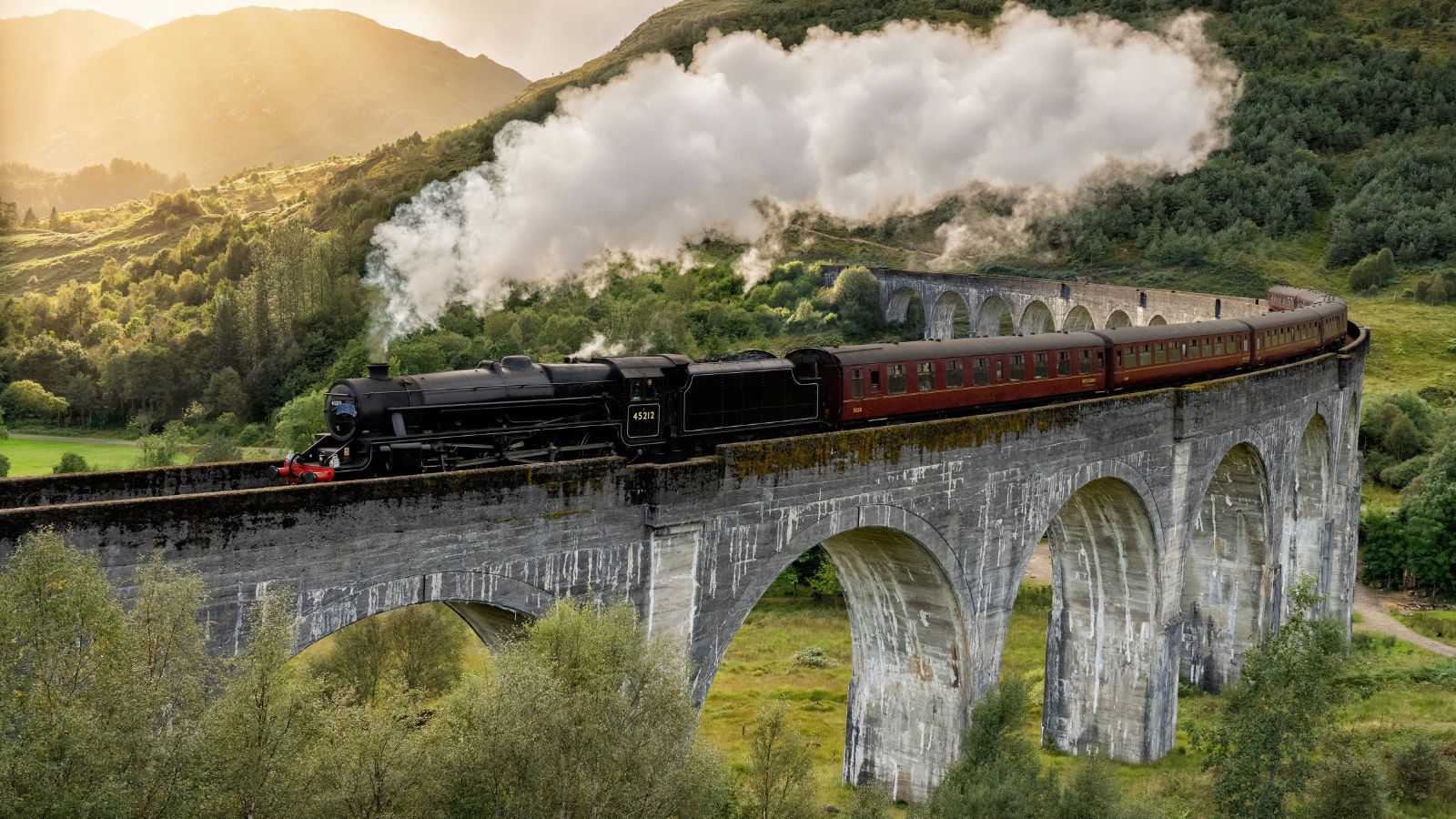 <p>Calling all Harry Potter fans! Remember those iconic shots of the Hogwarts Express chugging along a viaduct through rolling hills on its way to Hogwarts? Well, you can see it for yourself in Scotland.</p><p>In real life, you can watch the <em>Jacobite Steam Train</em> run across the <em>Glenfinnan Viaduct</em> by driving to the Glenfinnan Viaduct car park. From there, a signposted trail takes you to the perfect viewing point. Want to ride the train itself? It runs all week long from Fort William to Mallaig.</p>