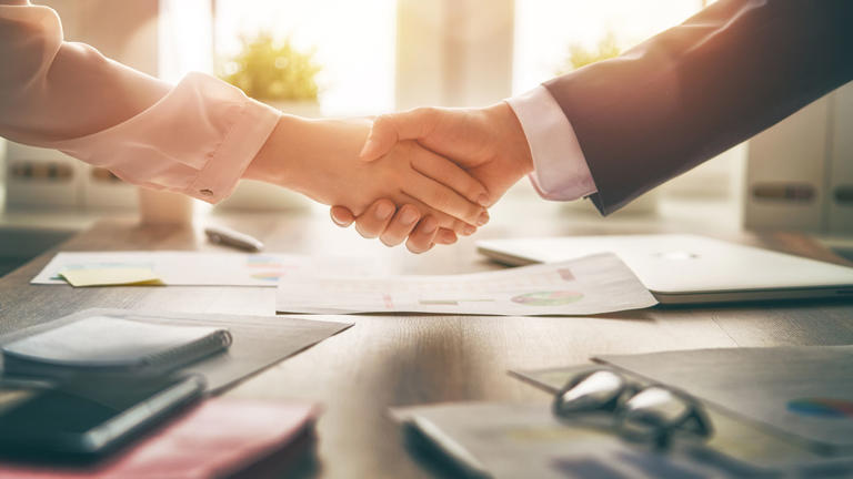 Business handshake in an office