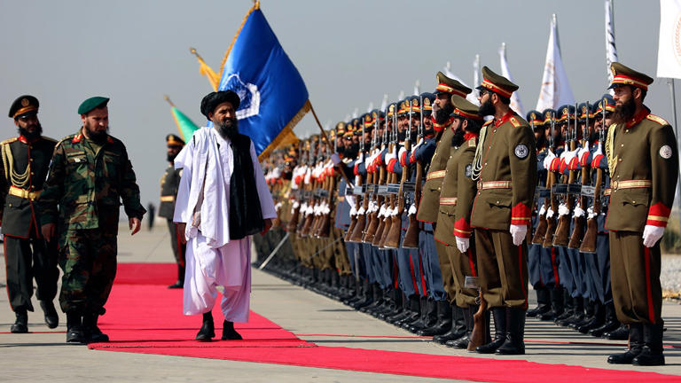 Mullah Abdul Ghani Baradar, the Taliban-appointed deputy prime minister for economic affairs, center, inspects the honor guards during a military parade to mark the third anniversary of the withdrawal of U.S.-led troops from Afghanistan, in Bagram Air Base in the Parwan Province of Afghanistan, Wednesday, Aug. 14, 2024. AP Images