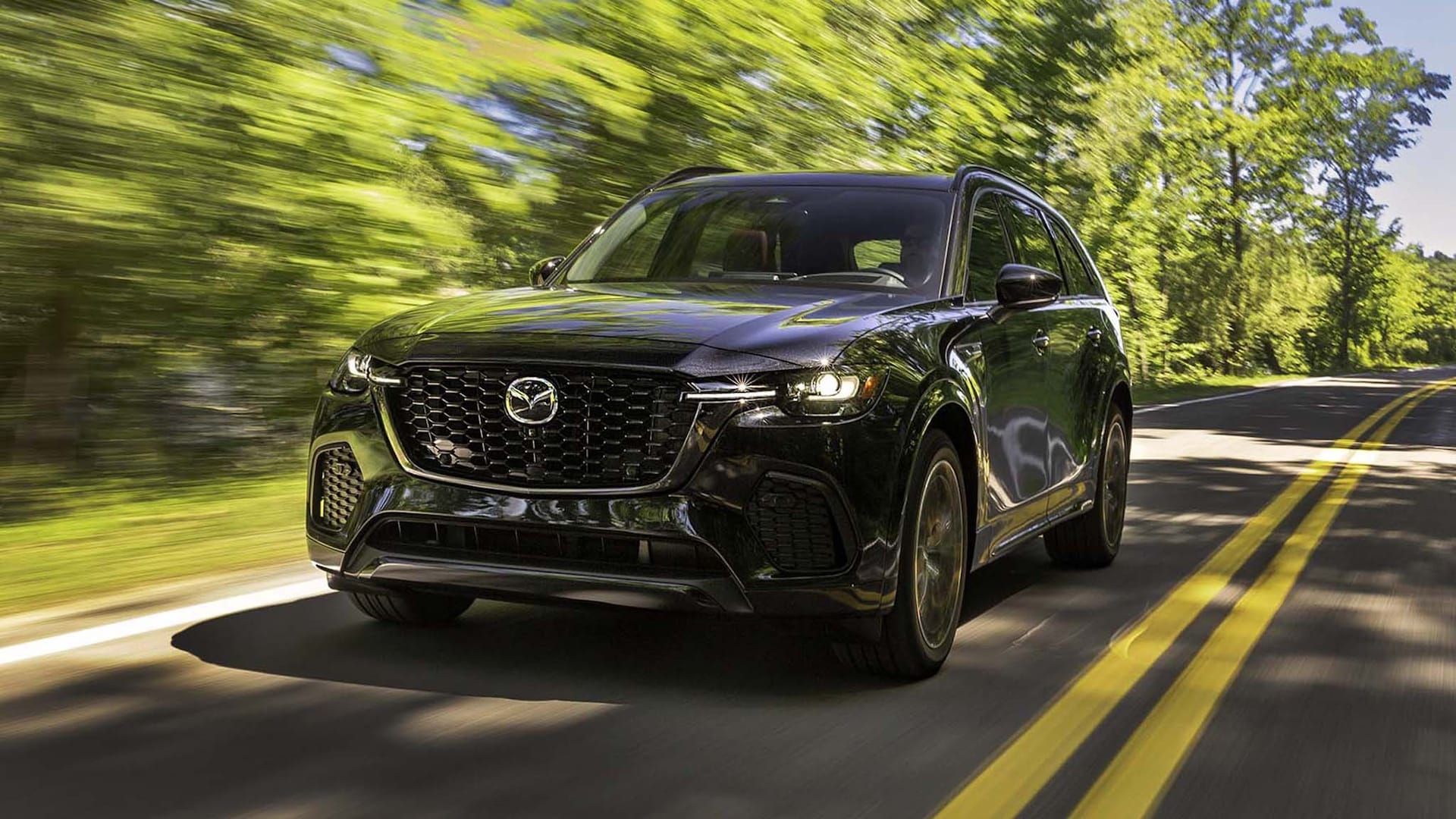 A modern Mazda CX-70 turbo performance SUV shown in a front exterior view, emphasizing its premium stance and sporty detailing.