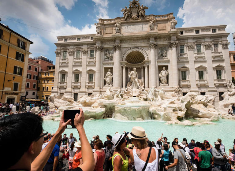 Tourists at the Trevi Fountain in Rome.