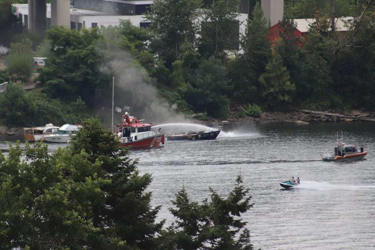 Crews respond to a boat fire on the east side of the Willamette River near the Hawthorne Bridge in downtown Portland on Thursday, Aug. 15, 2024.