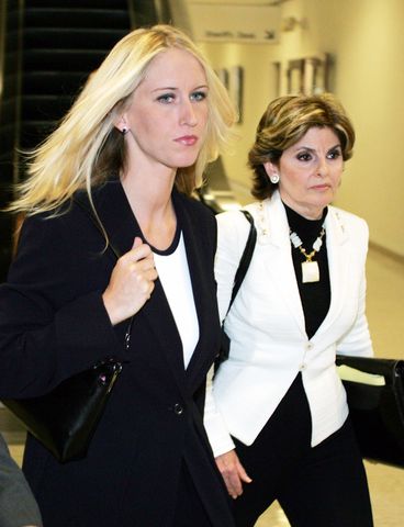 Amber Frey (L) leaves the San Mateo County Courthouse flanked by her lawyer Gloria Allred after Frey