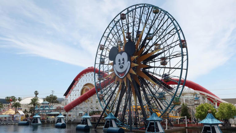 People ride on the Pixar Pal-A-Round ferris wheel in front of the Incredicoaster in the Disney California Adventure Park at Disneyland on April 11, 2023, in Anaheim, California. - Gary Hershorn/Corbis News/Getty Images