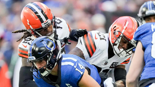 Indianapolis Colts wide receiver Alec Pierce (14) works to evade tackle by Cleveland Browns cornerback Martin Emerson Jr. (23) and Cleveland Browns cornerback Denzel Ward (21) on Sunday, Oct. 22, 2023, during a game against the Cleveland Browns at Lucas Oil Stadium in Indianapolis. | Robert Scheer/IndyStar / USA TODAY NETWORK