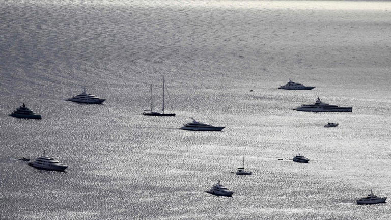 A photo of superyachts anchored in the Med. 