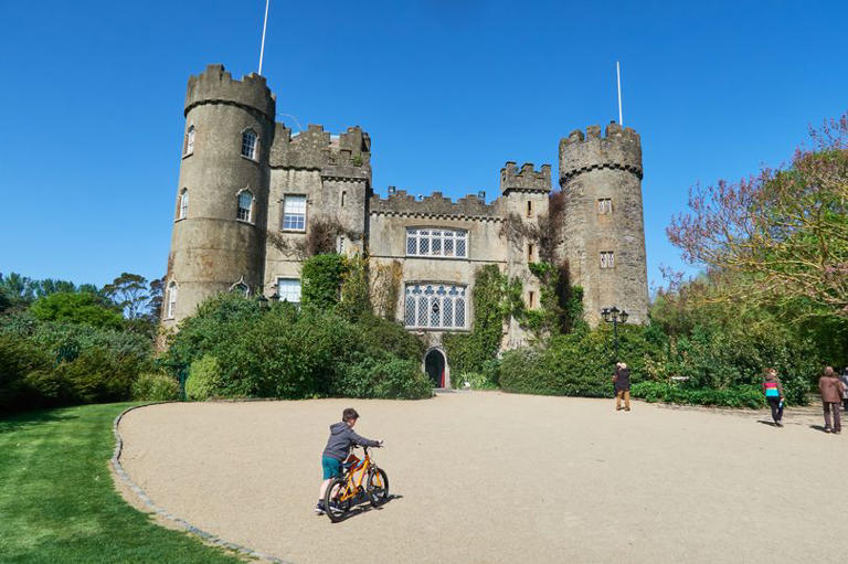 MALAHIDE, IRELAND - MAY 15: Kid with a bicycle in front of the impressive Medieval Malahide Castle on May 15, 2018 in Malahide, Ireland. (Photo by EyesWideOpen/Getty Images)