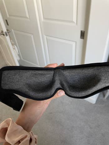 Jasmin holding the eye mask to show the contoured eye cups