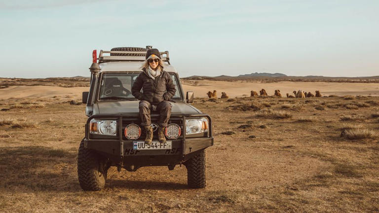 Writer Breanna Wilson sits atop her prized 1978 Toyota Land Cruiser, which she drove solo through Central Asia to her new home in Mongolia.