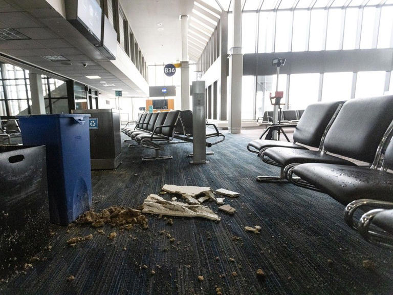 Wet ceiling tiles rest on waterlogged carpet in Terminal B of Calgary International Airport on Tuesday, August 6, 2024, where a hail storm led to significant water damage the night before.