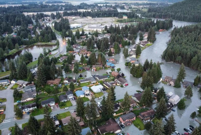 A melting glacier, overflowing from heavy rains in Alaska, unleashed a torrent of water Tuesday on Juneau where more than 100 homes were damaged.