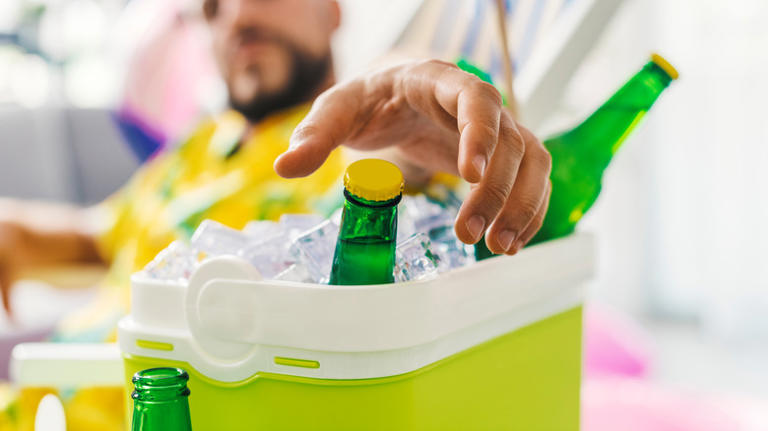 person reaching into cooler