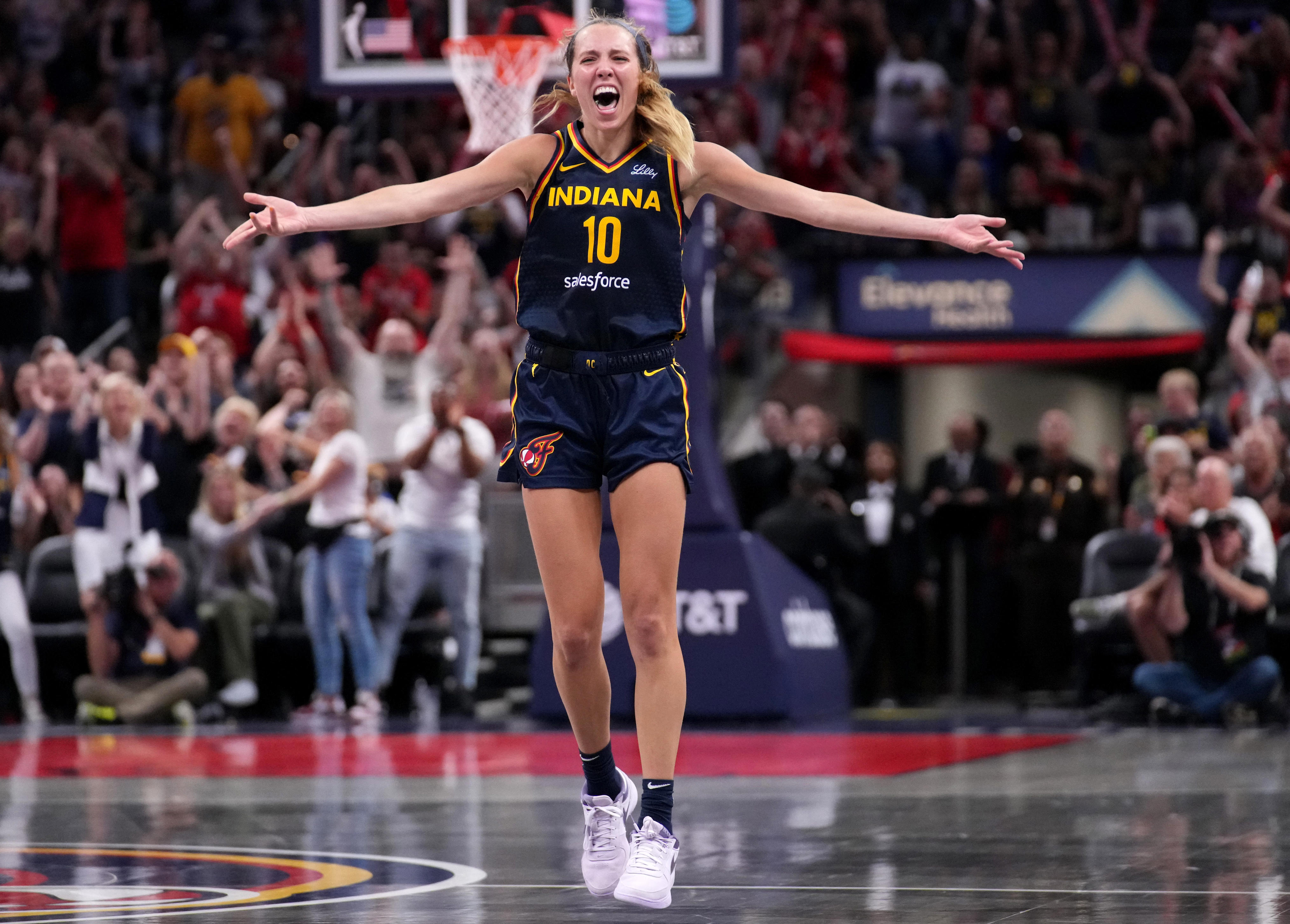 Indiana Fever guard Lexie Hull (10) celebrates after scoring a three-point field goal during the second half of a game against the Seattle Storm on Sunday, Aug. 18, 2024, at Gainbridge Fieldhouse in Indianapolis. The Fever defeated the Storm 92-75.