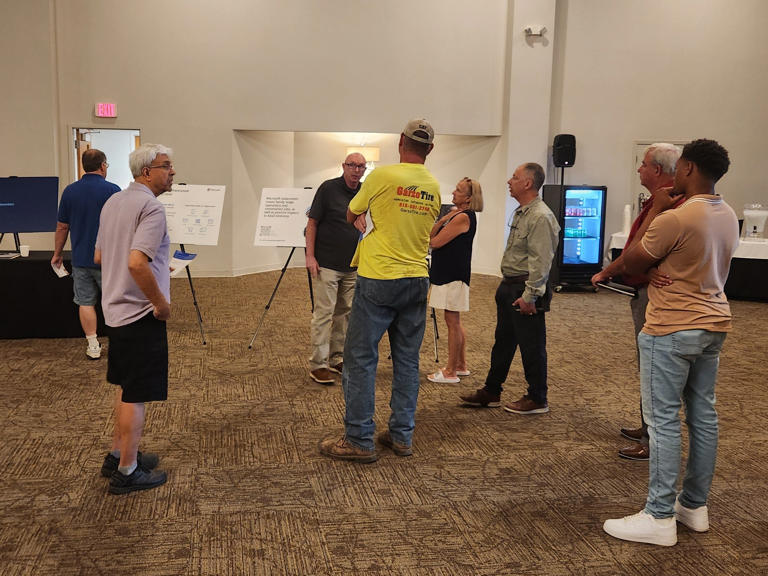 Residents view information boards at a Microsoft data center open house information session Monday, Aug. 19, 2024, at the Tebala Event Center, 7910 Newburg Road.