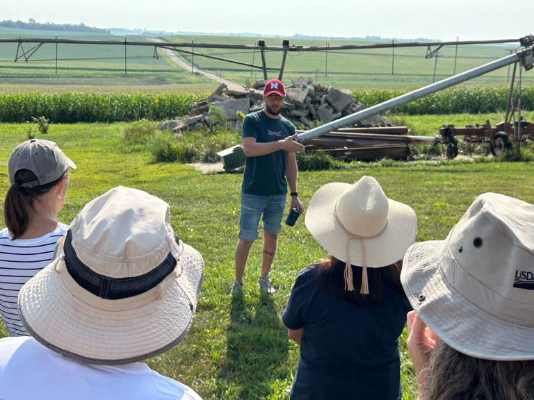 Graham Christensen explains the regenerative agriculture practices employed at his family’s farm east of Lyons to produce crops with less intensive use of pesticides and fertilizers during a farm tour Saturday.