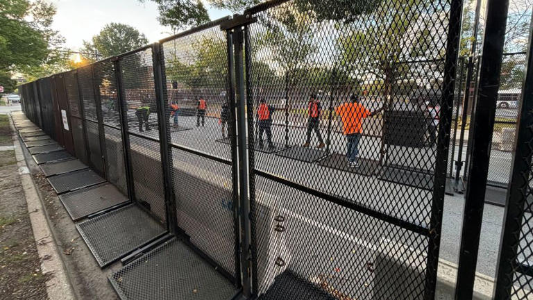 Chicago workers set up an additional line of security fences outside the United Center on Tuesday morning. - Bill Kirkos/CNN