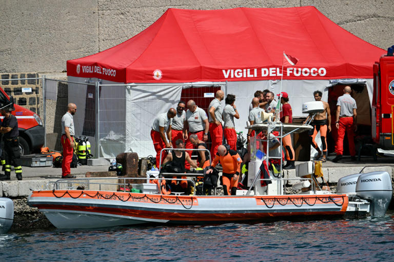 Divers of the Vigili del Fuoco, the Italian Corps. of Firefighters, return to Porticello on a small boat, on August 20, 2024 near Palermo a day after the British-flagged luxury yacht Bayesian sank. Specialist divers launched a fresh search for six people, including UK tech tycoon Mike Lynch and the chairman of Morgan Stanley International, missing since their yacht capsized off the Italian island of Sicily. The Bayesian, which had 22 people aboard including 10 crew, was anchored some 700 metres from port before dawn when it was struck by a waterspout, a sort of mini tornado.