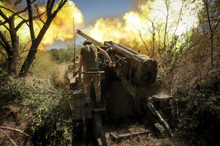 A Ukrainian serviceman of the 24th Mechanized Brigade fires a 2s5 'Hyacinth-s' 152 mm self-propelled howitzer towards Russian positions at an undisclosed location in Donetsk region