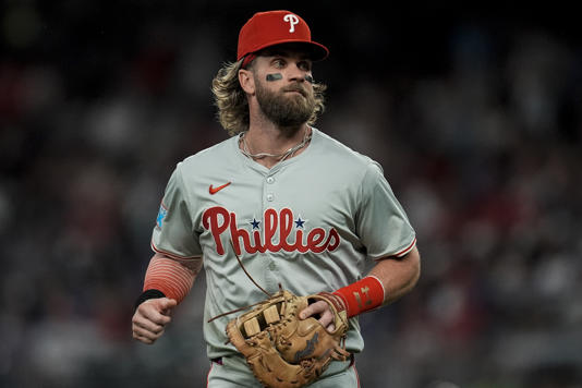 Philadelphia Phillies first baseman Bryce Harper (3) runs to the dugout in the fifth inning of a baseball game against the Atlanta Braves, Tuesday, Aug. 20, 2024, in Atlanta. (AP Photo/Mike Stewart)